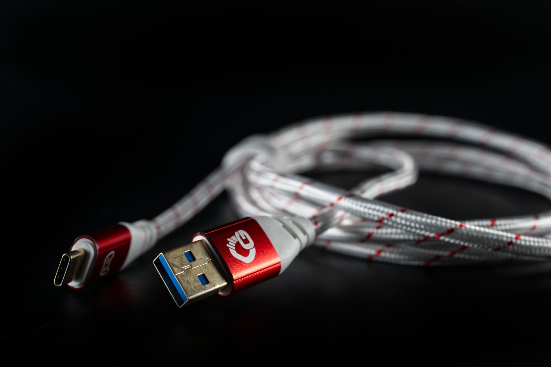 USB-A- und USB-C-Stecker in Rot mit rot-weißem Geflecht